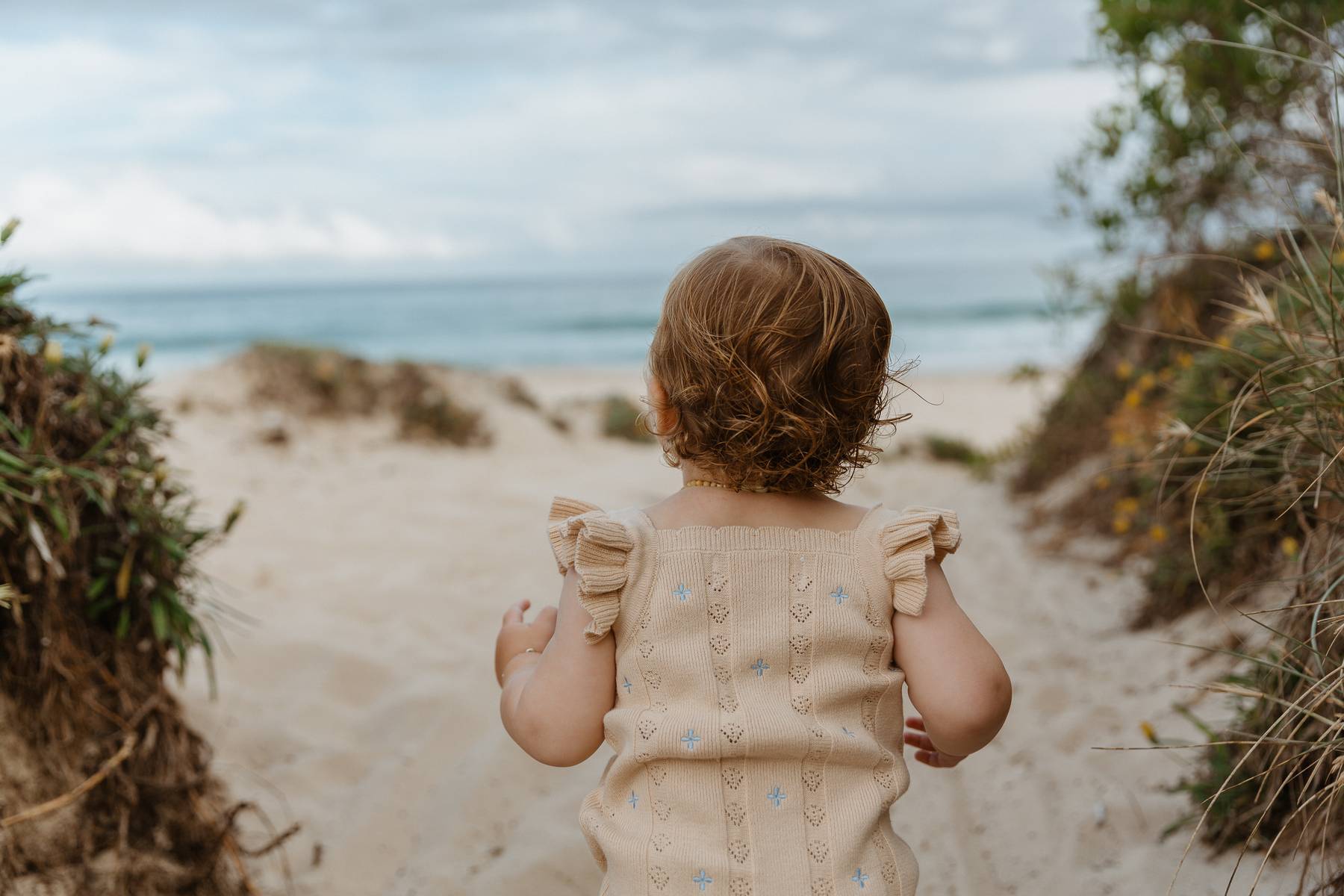 Sienna Ruffle Knit Pointelle Romper | Coastal Beige | WYLDE. Wylde. Clothing for Kids