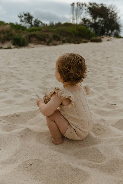 Sienna Ruffle Knit Pointelle Romper | Coastal Beige | WYLDE. Wylde. Clothing for Kids