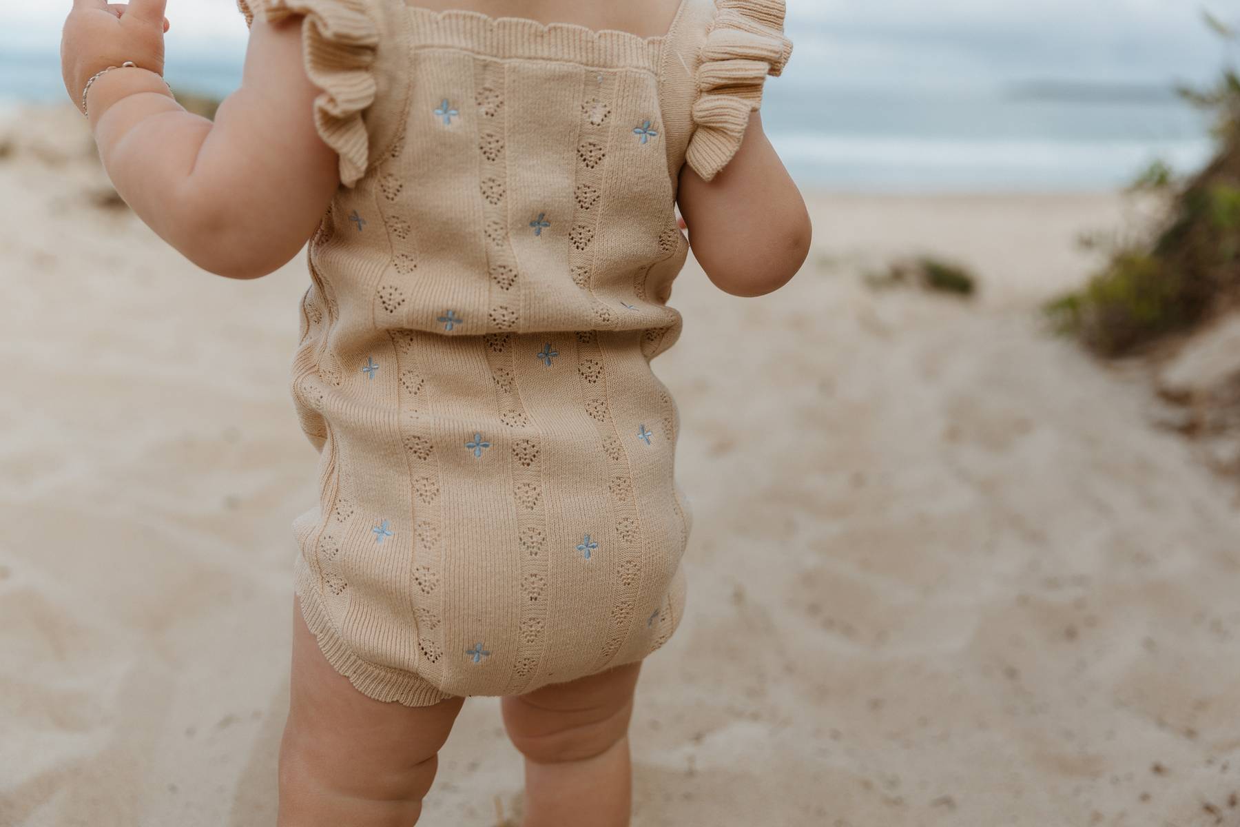 Sienna Ruffle Knit Pointelle Romper | Coastal Beige | WYLDE. Wylde. Clothing for Kids
