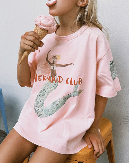 Person wearing a pink 'Mermaid Club' t-shirt holding an ice cream cone.