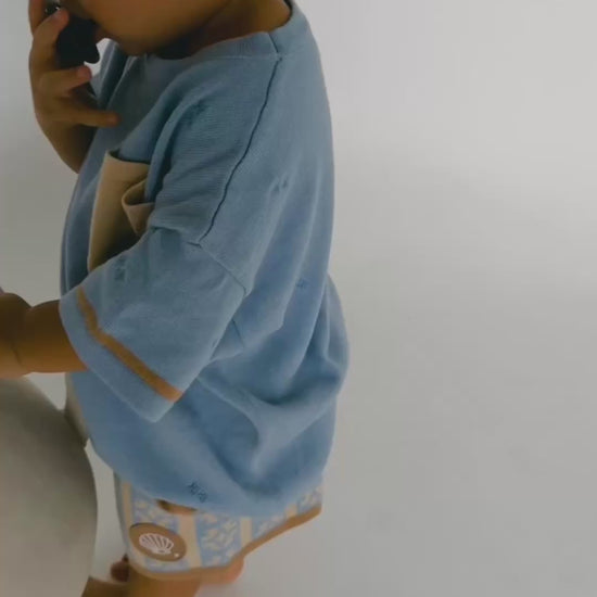 Toddler boy running around in oasis cove oversized tee and shorts 